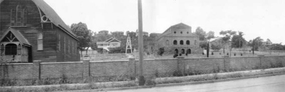 Archival photograph of early church and school buildings.