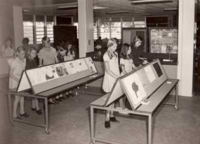 Archival photograph of students viewing classroom displays.