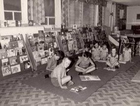 Archival photograph of students reading in a classroom.